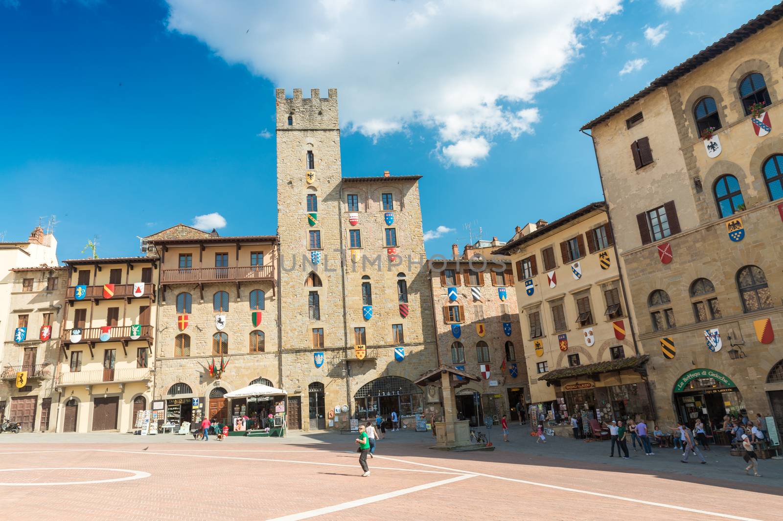 AREZZO, ITALY - MAY 12, 2015: Tourists enjoy Piazza Grande on a by jovannig