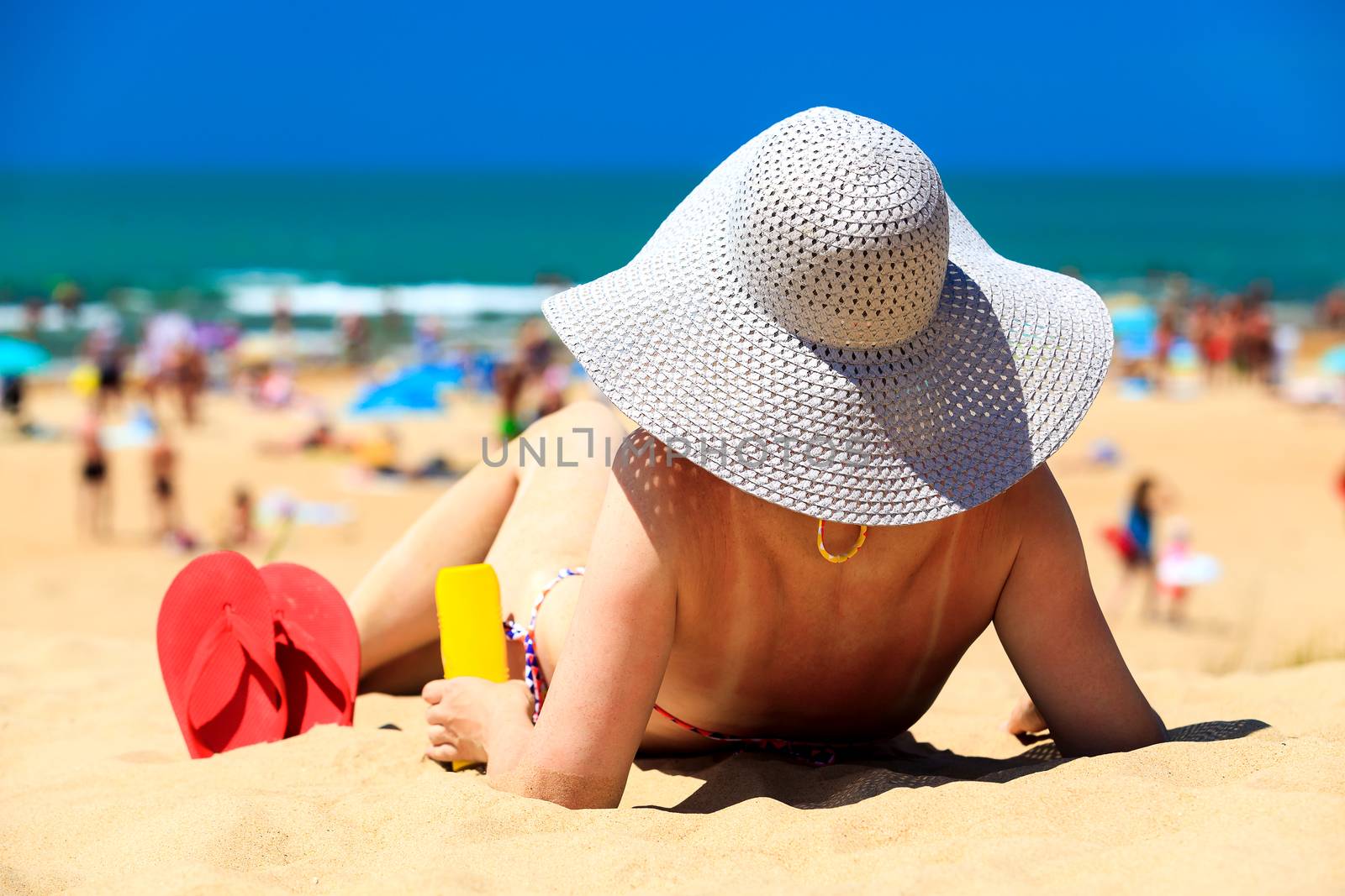 Woman on a beach by Nobilior