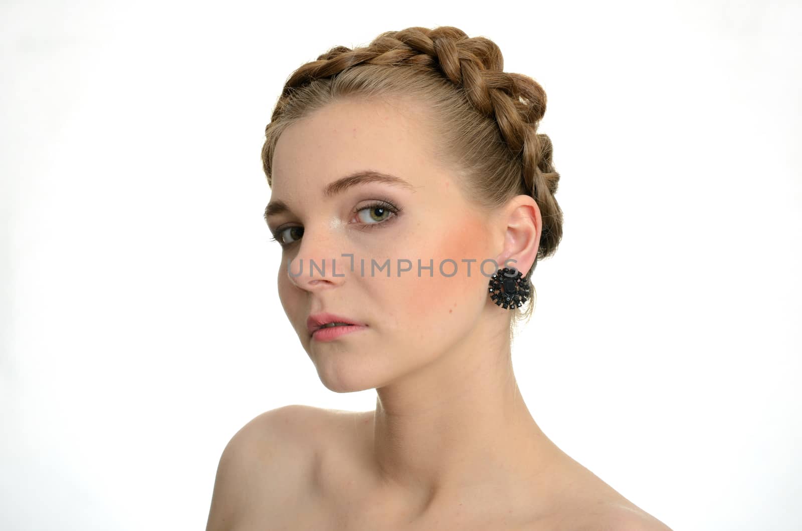 Young female model wearing black earrings. Gentle face expression.