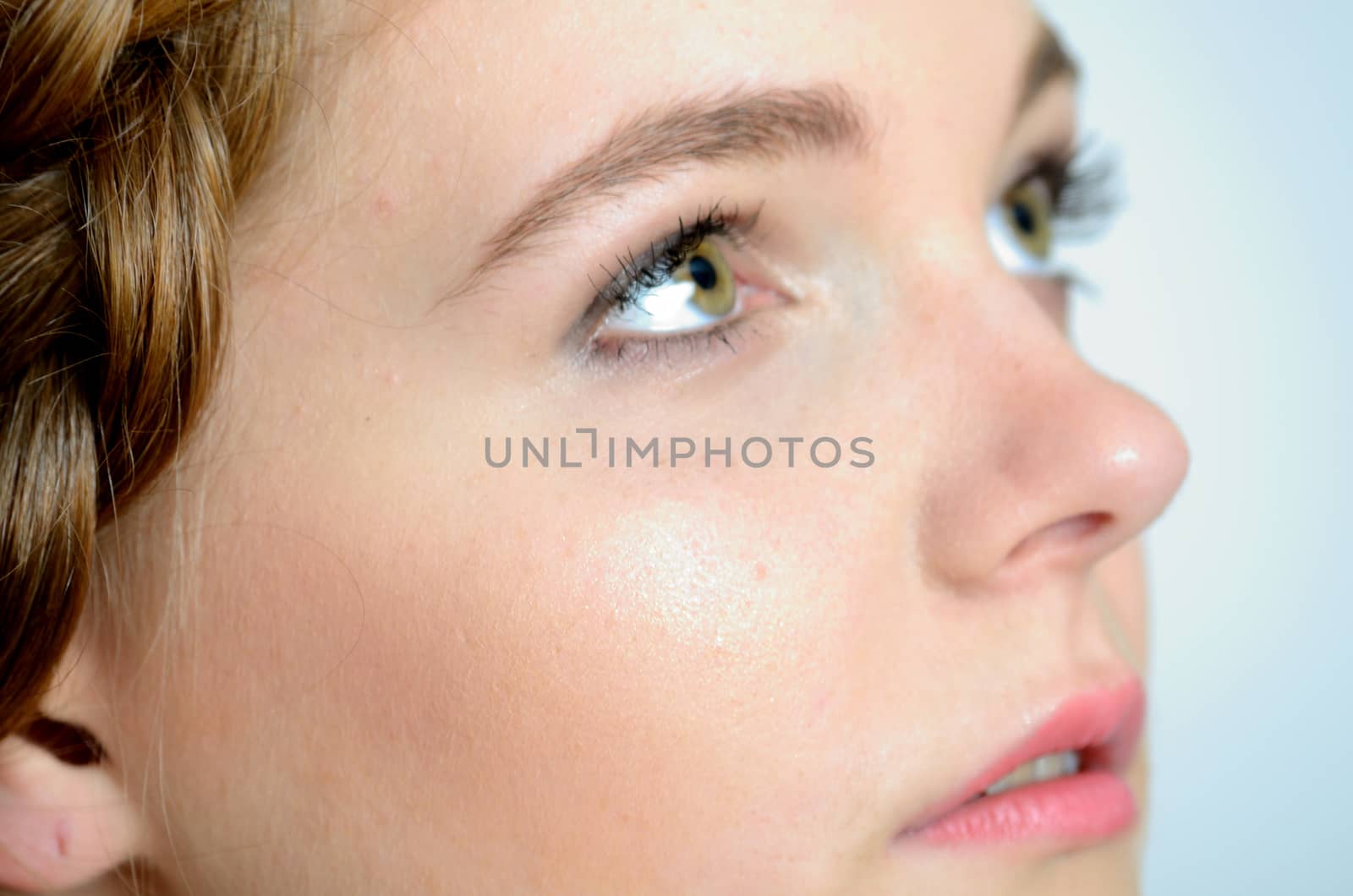 Closeup photo of face. Young female model with gentle face expression.
