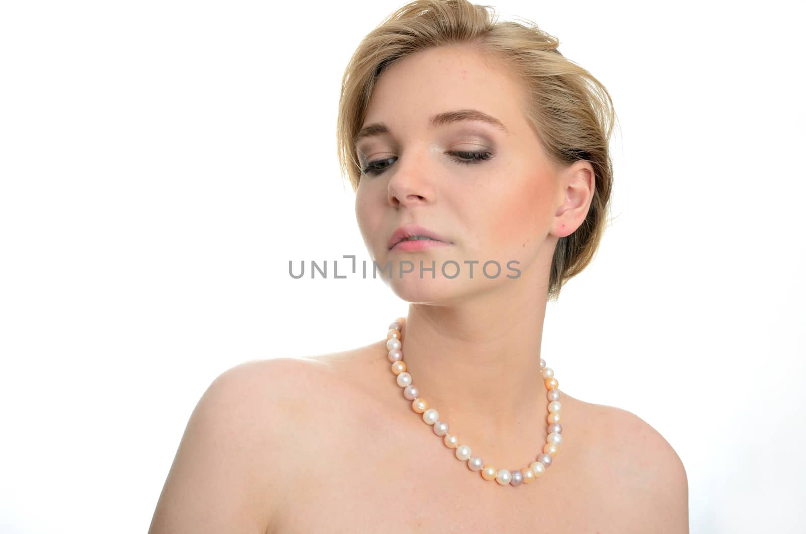 Young model wearing pealrs necklace. Female model with proud face expression.