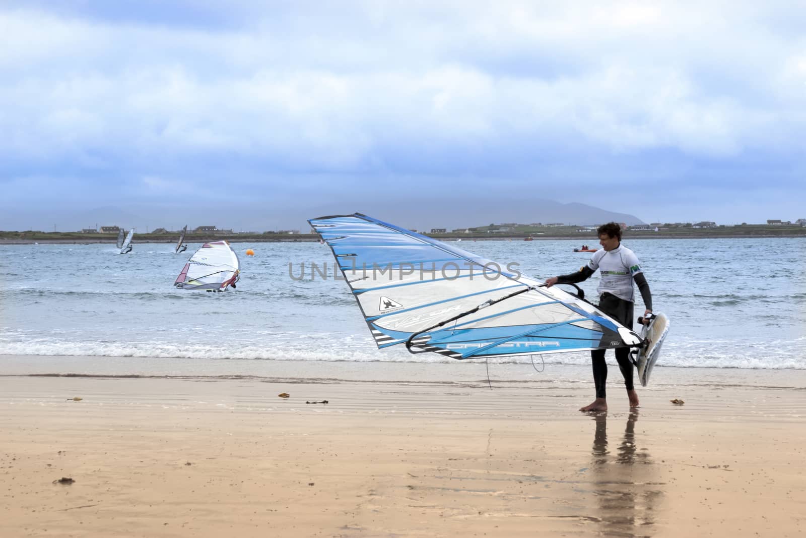 windsurfing champion getting ready to race and surf on the beach in the maharees county kerry ireland