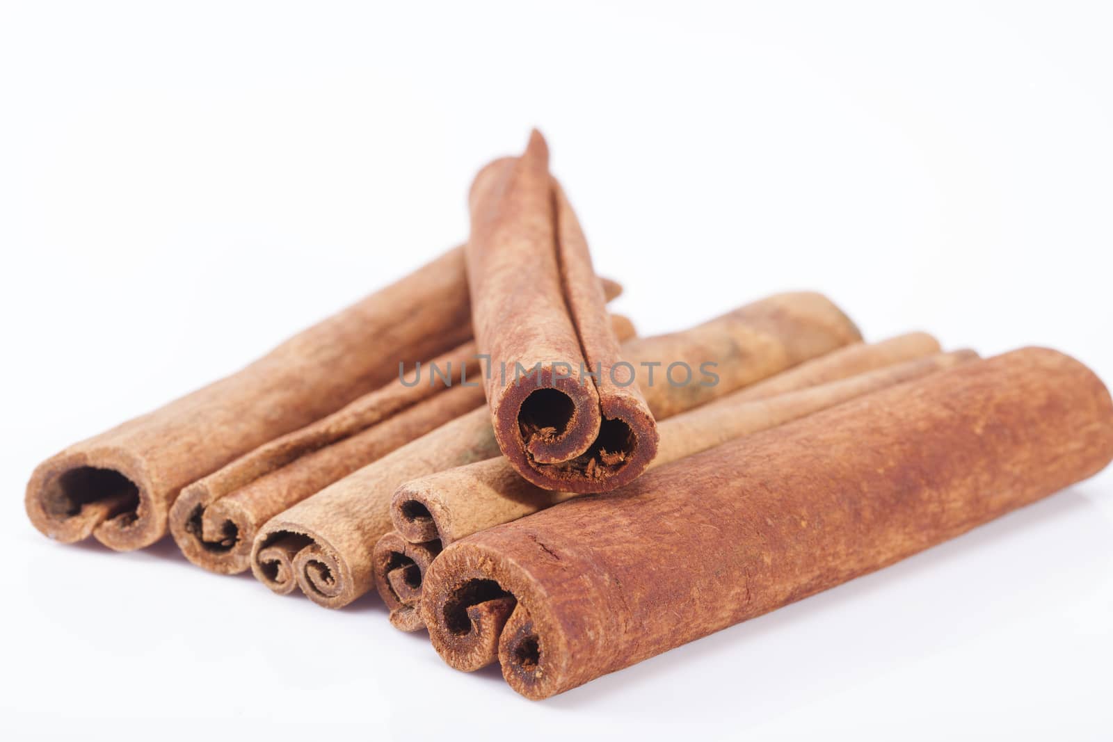 group of dried cinnamon stics isolated on white background