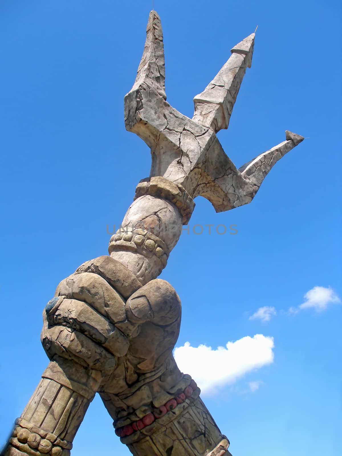 A stone trident with sky and clouds