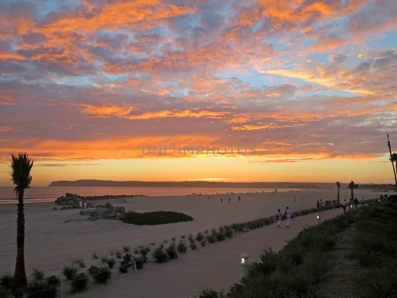 A colorful sunset over the ocean and beach