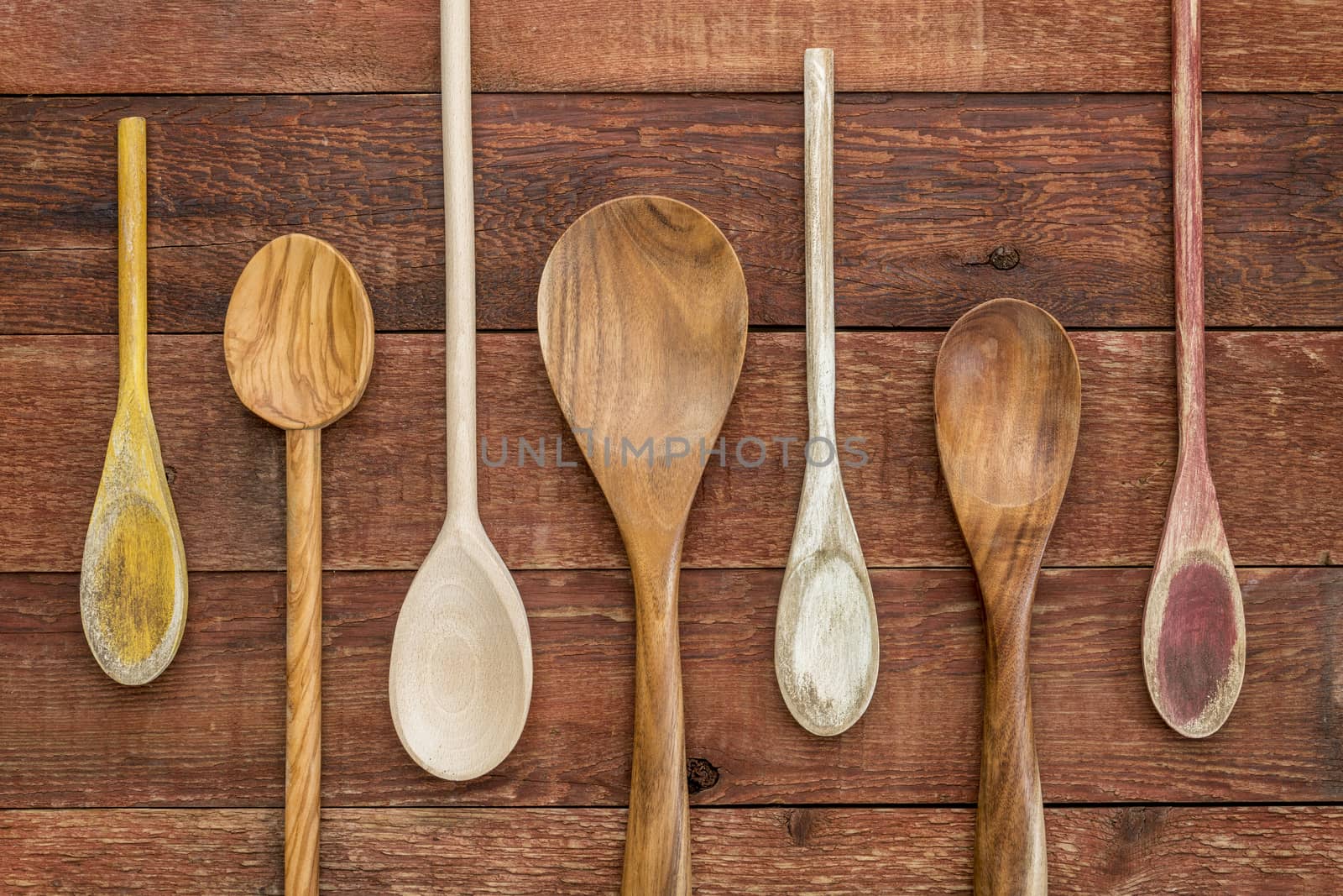 set of wooden spoons against a rustic barn wood table