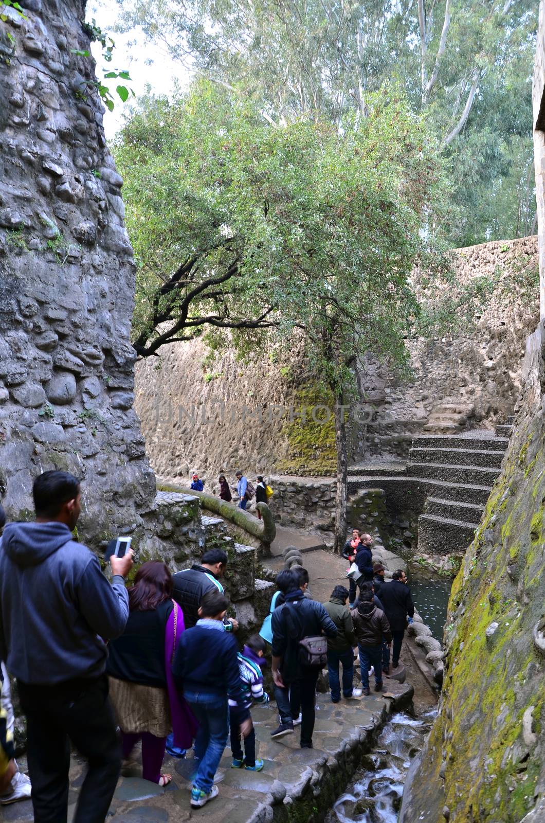 Chandigarh, India - January 4, 2015: People visit Rock garden on January 4, 2015 in Chandigarh, India. The rock garden was founded by artist Nek Chand in 1957 and is made completely of recycled waste.