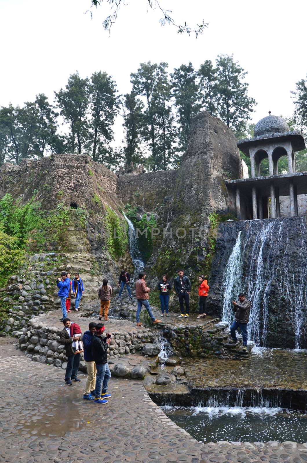 Chandigarh, India - January 4, 2015: People visit Rock statues at the rock garden on January 4, 2015 in Chandigarh, India. The rock garden was founded by artist Nek Chand in 1957 and is made completely of recycled waste.