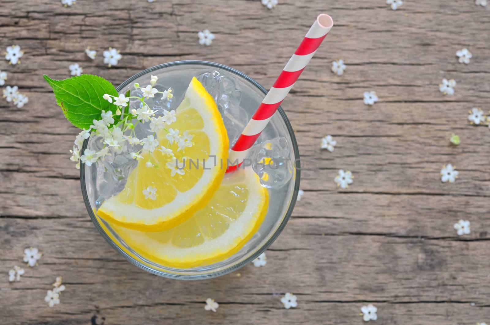 Elder lemonade with ice on old table wood