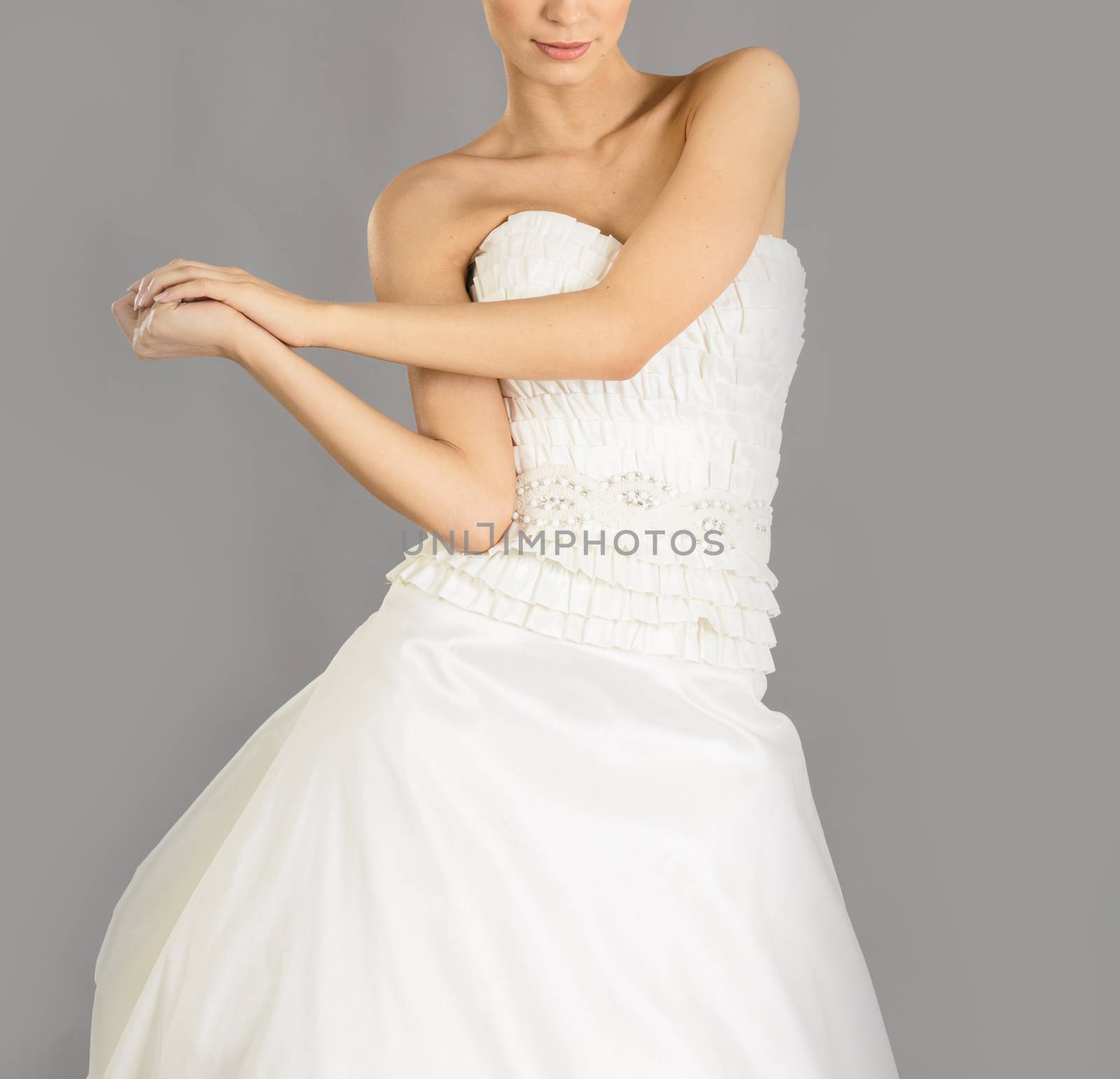 Beautiful bride on grey background. Studio shot