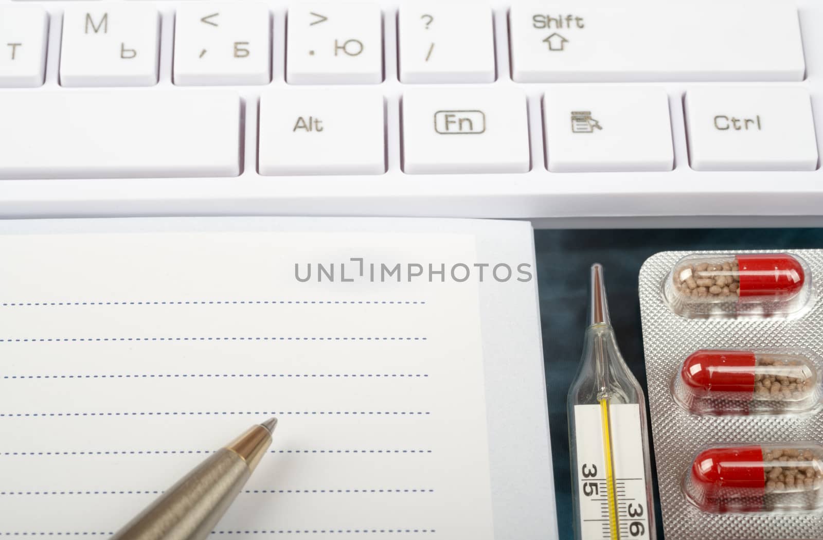 X-ray examination, notebook and keyboard with thermometer, drugs, close up view