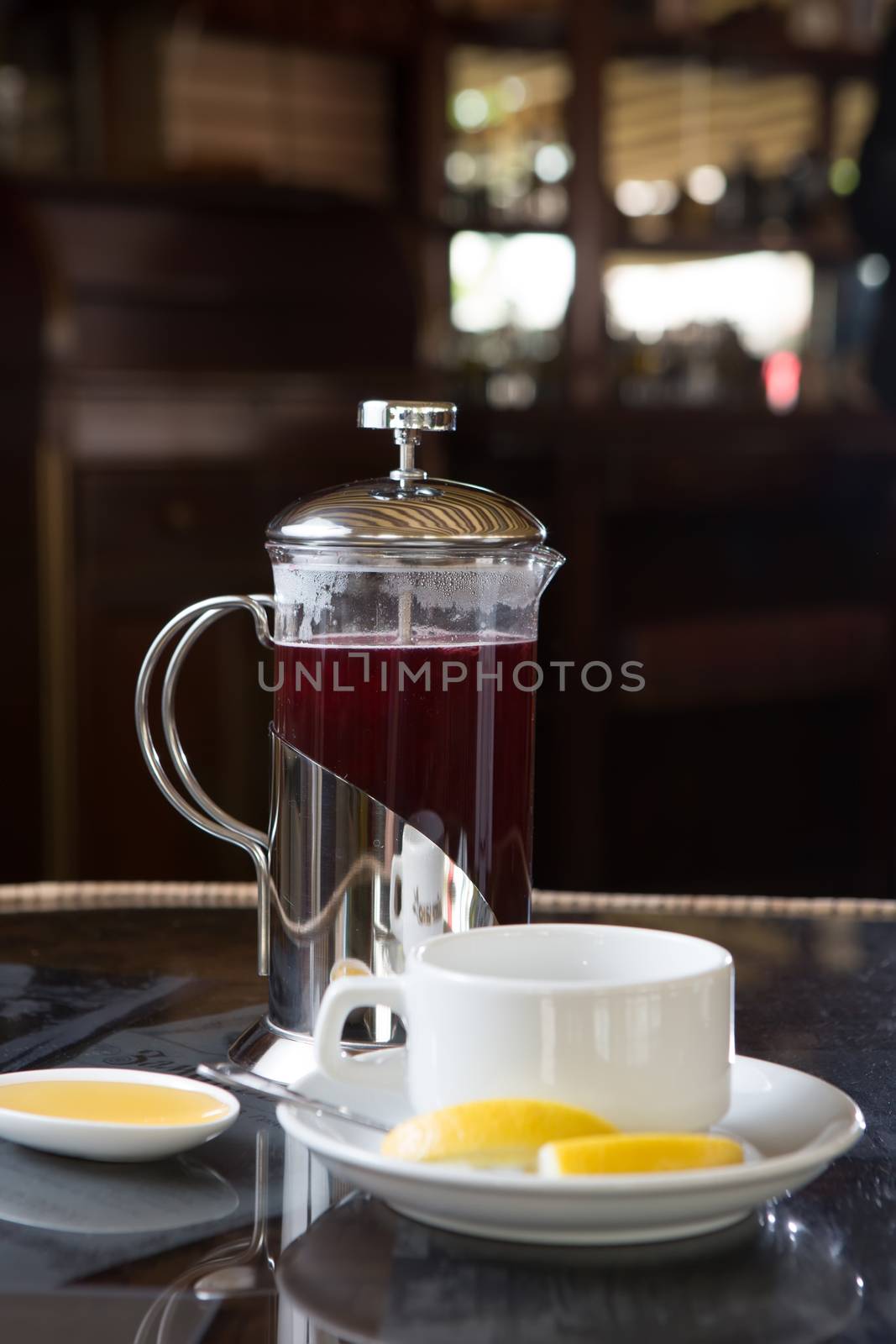 Cup of tea with honey and lemon in street cafe