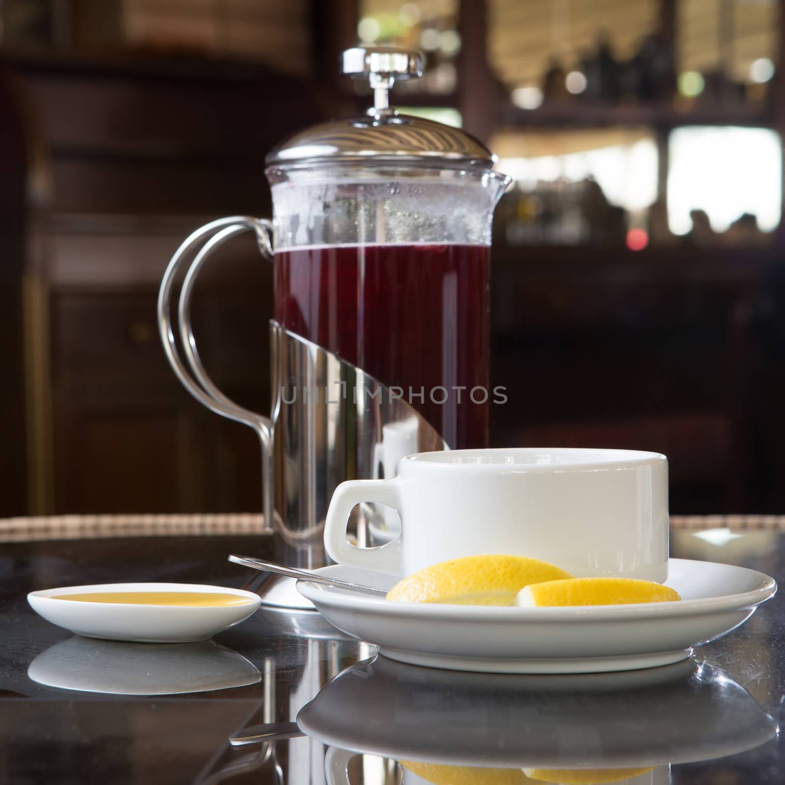 Cup of tea with honey and lemon in street cafe