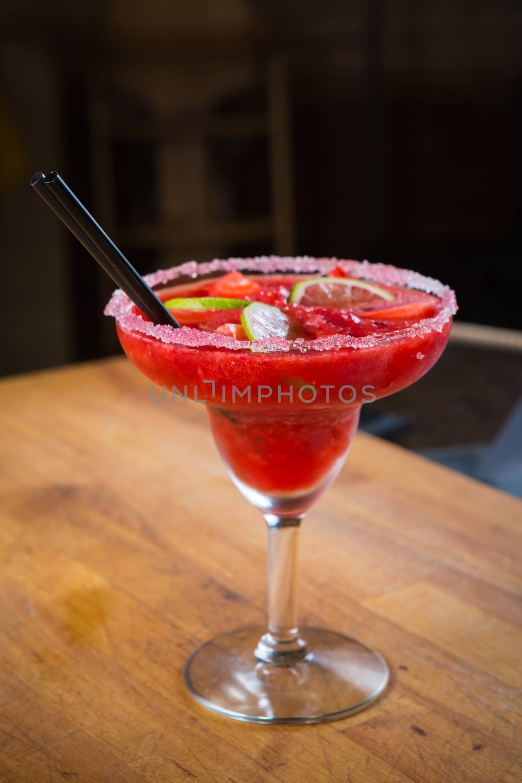 Strawberry margarita cocktail on the bar. Shallow dof