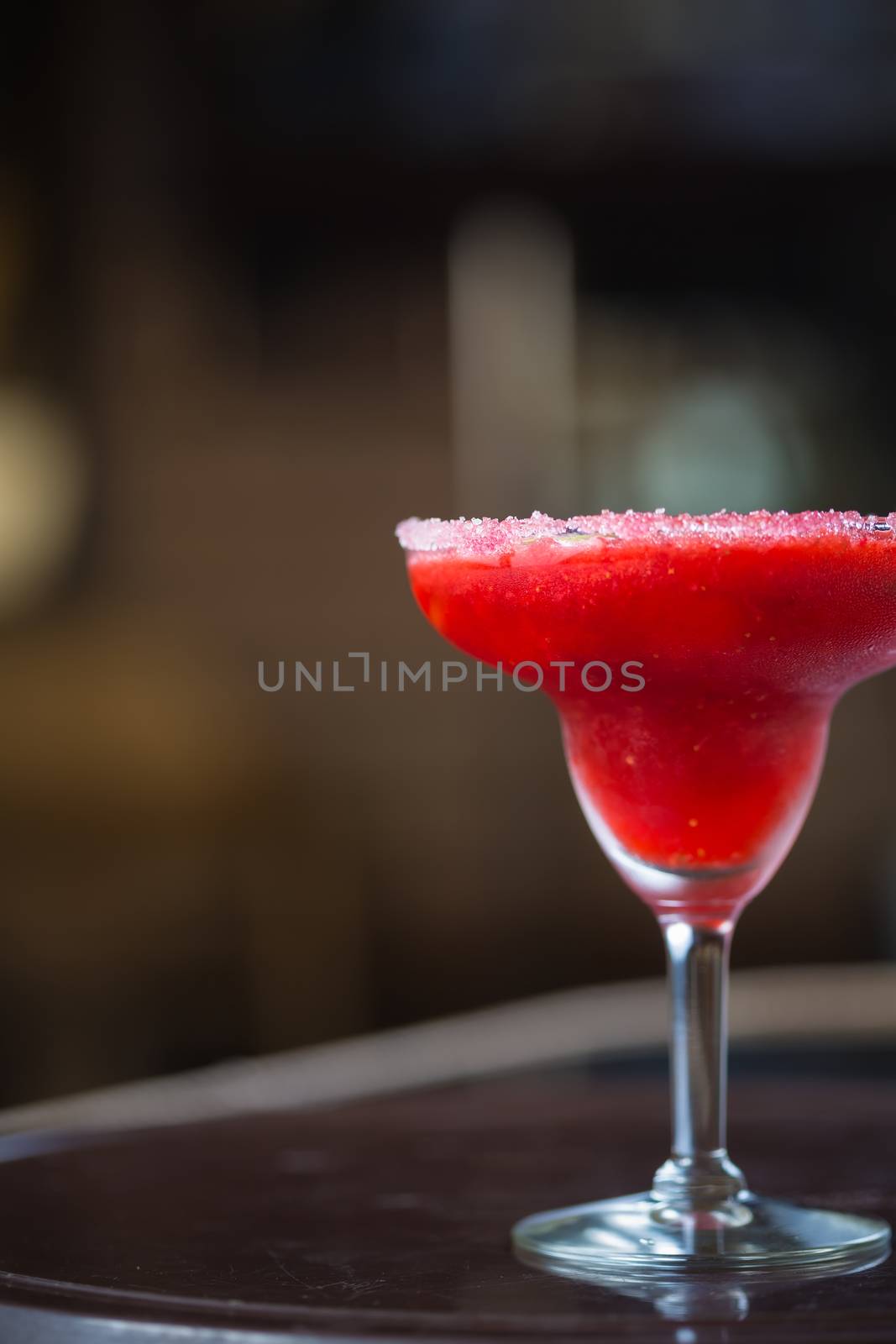 Strawberry margarita cocktail on the bar. Shallow dof