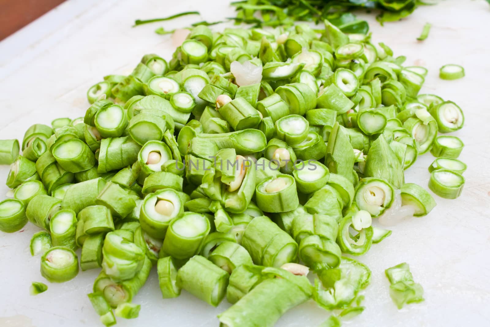 Sliced Green Beans (Phaseolus sp.) on the White Plastic Chopping Board