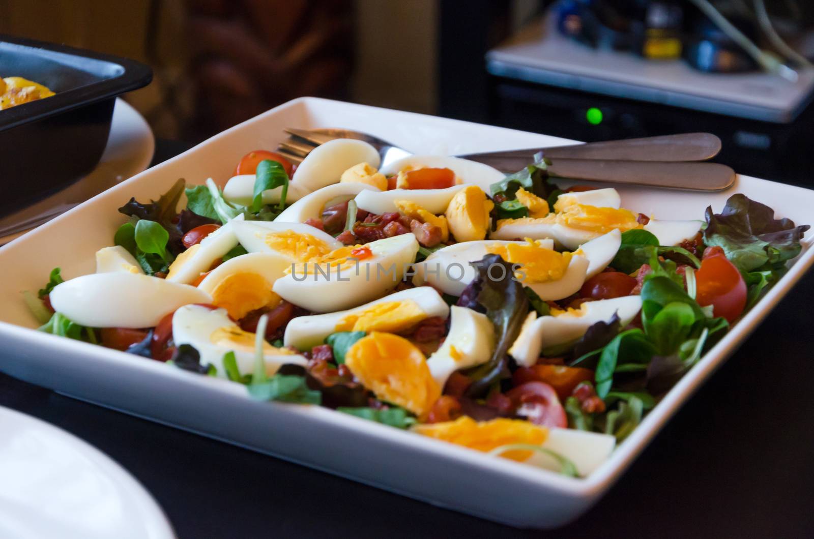 Salad with tomato, lettuce and quail eggs by siraanamwong