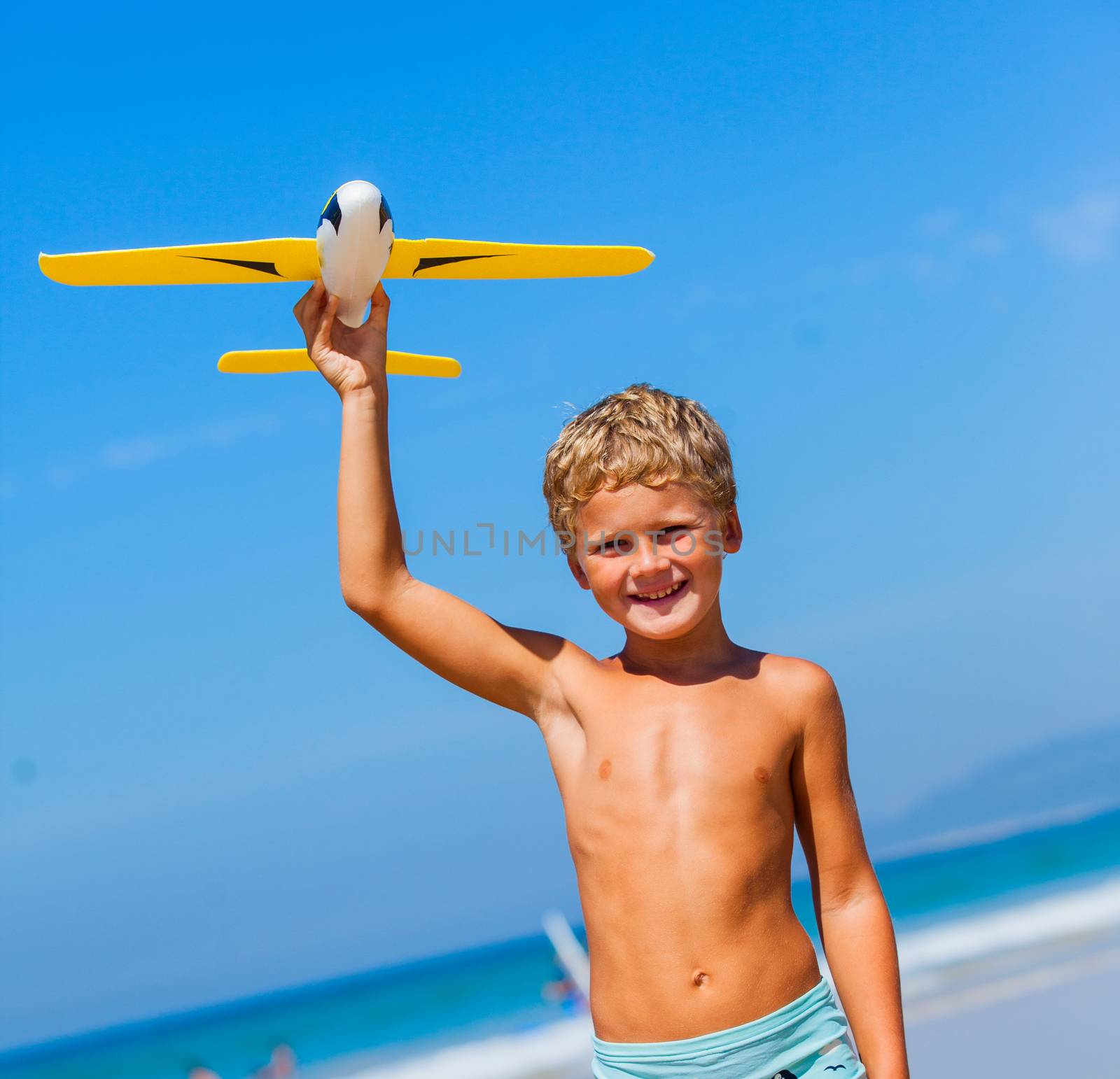 Beach kid boy kite flying outdoor coast ocean