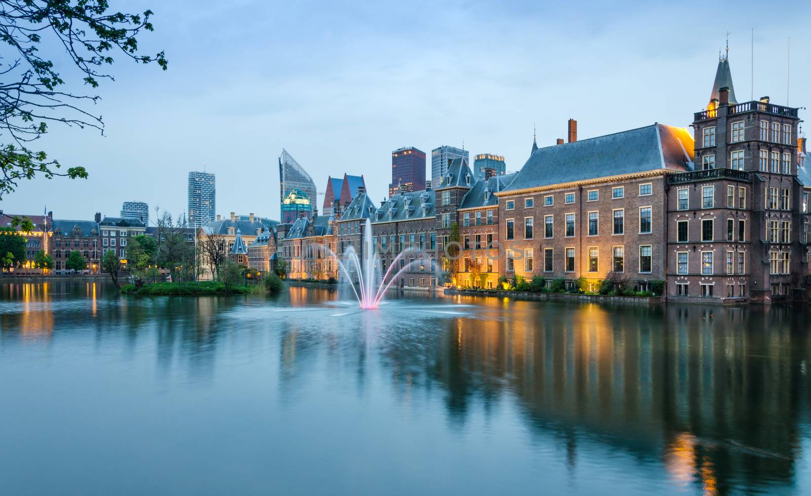 Dutch parliament buildings Binnenhof with skyscrapers in the background in The Hague, Netherlands, Twilight time.