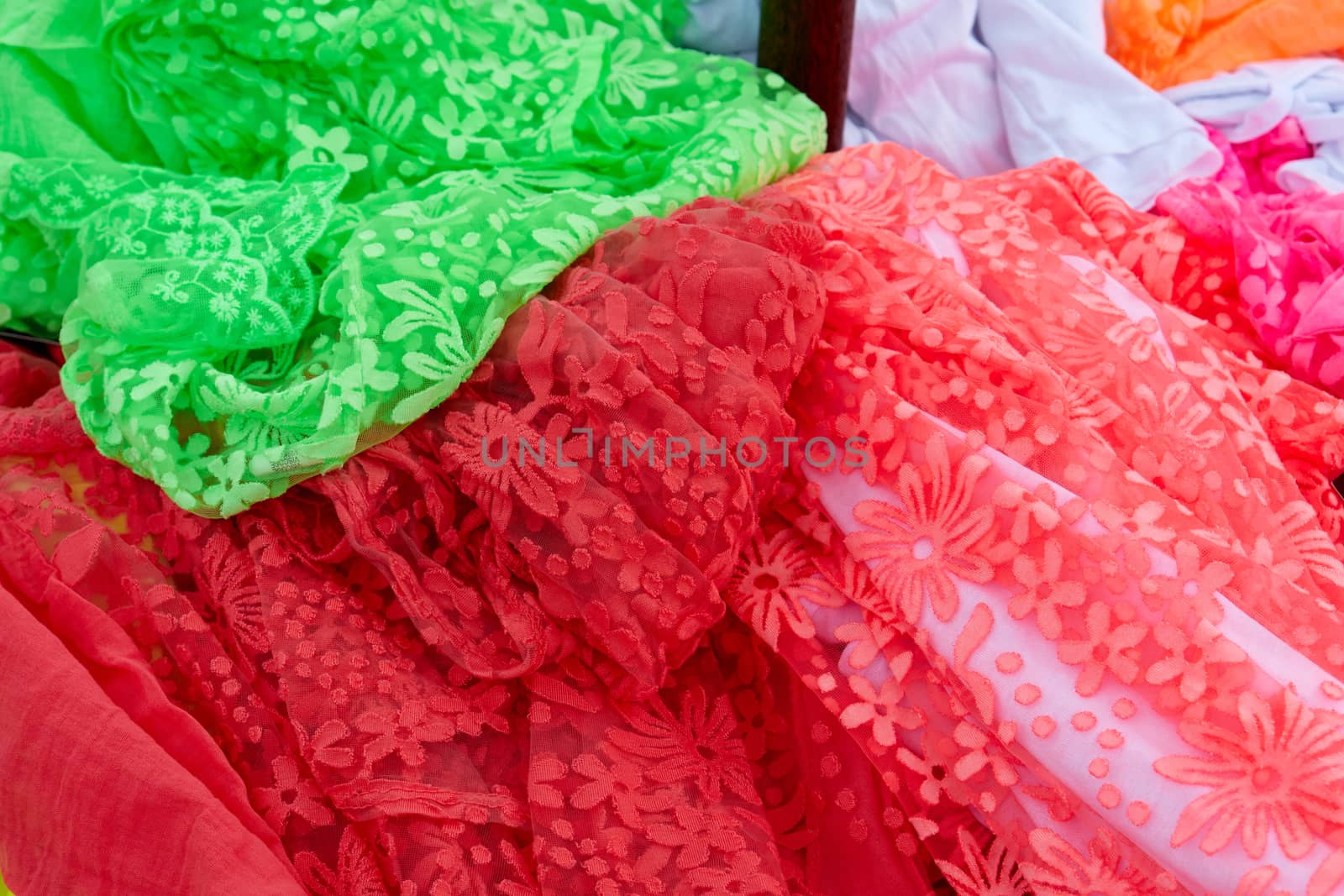 Beautiful colorful scarves hanging  in a fashion accessories shop                                        