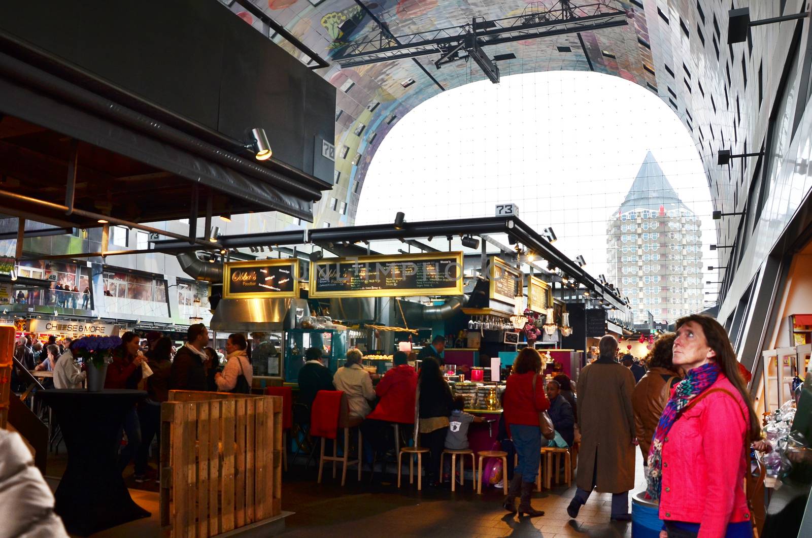 Rotterdam, Netherlands - May 9, 2015: People visit Markthal (Market hall) a new icon in Rotterdam. The covered food market and housing development shaped like a giant arch by Dutch architects MVRDV.