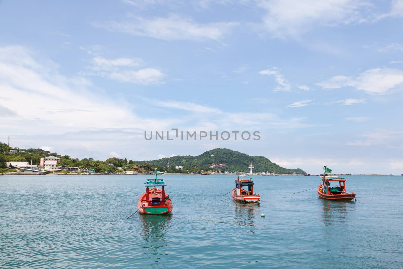 Small fishing boats Parking in the sea near the island dock.