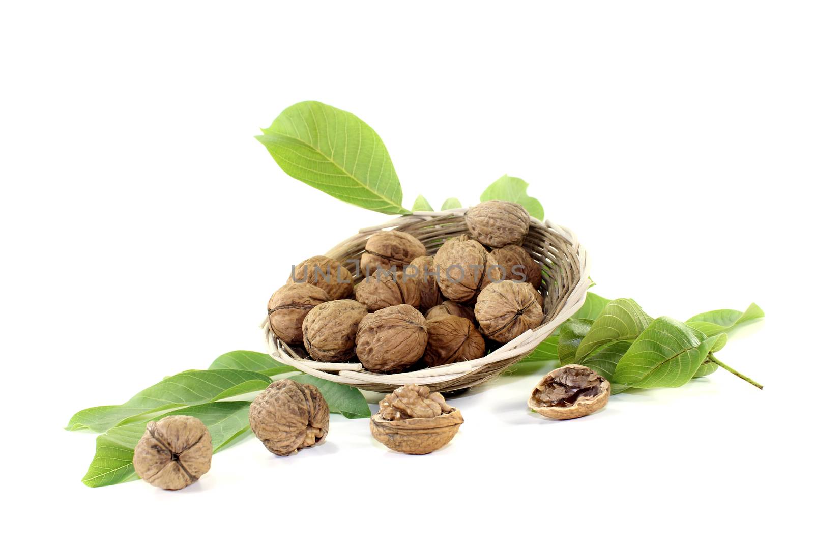 crunchy walnuts with walnut leaves in a basket by discovery