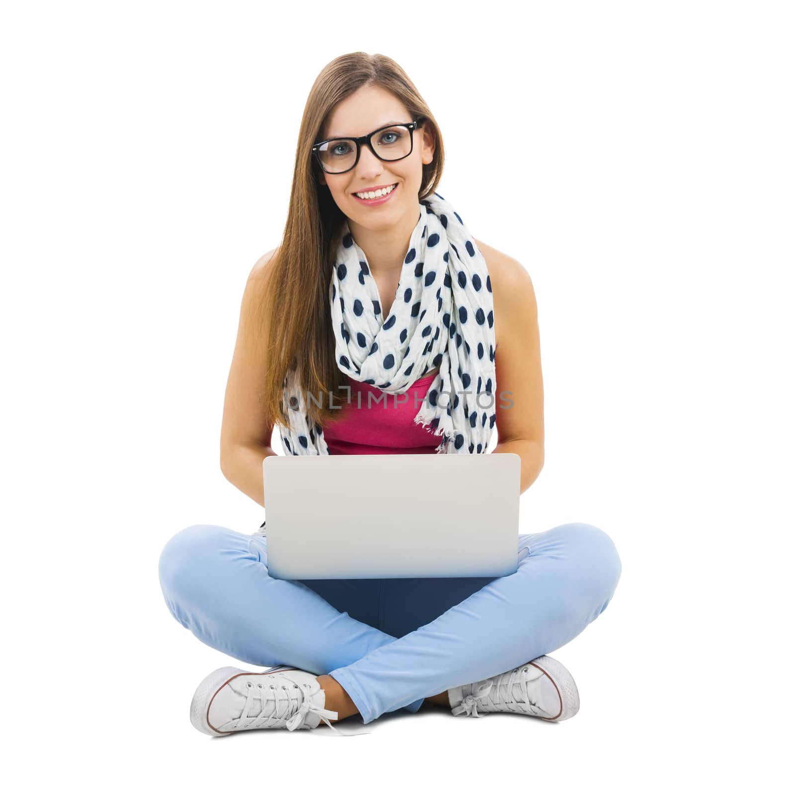 Beautiful woman sitting with crossed legs working with a laptop