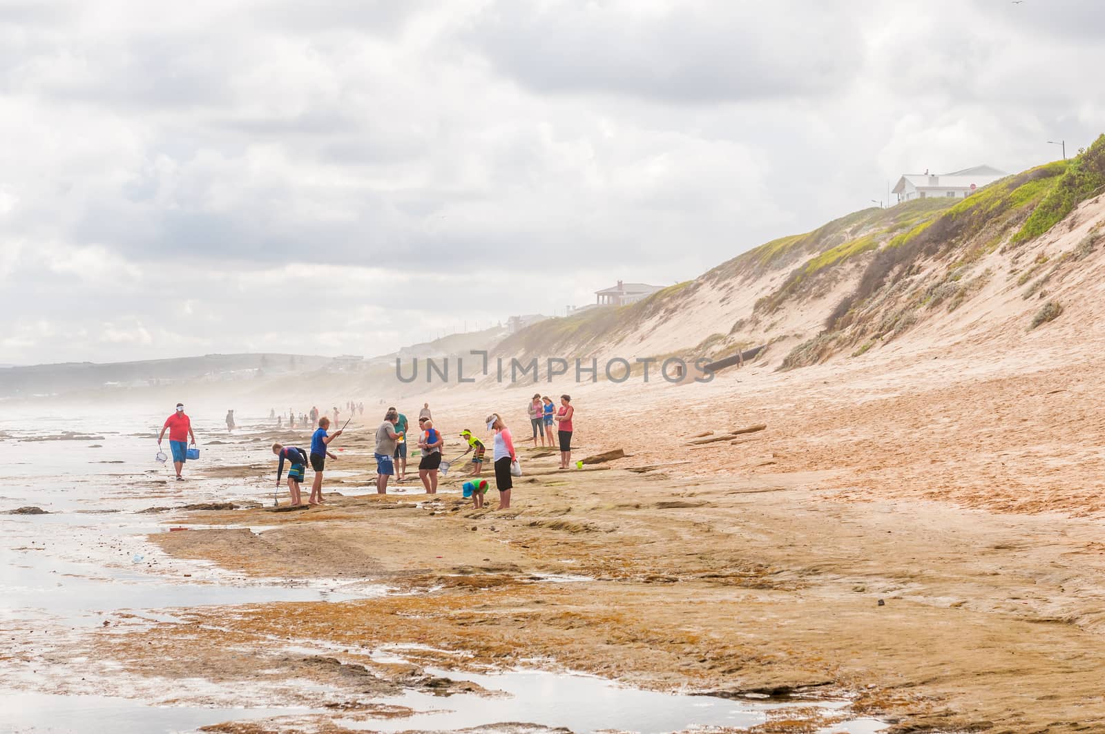 MOSSELBAY, SOUTH AFRICA - DECEMBER 28, 2014: Unidentified tourists enjoying a hazy day at the beach in Reebok