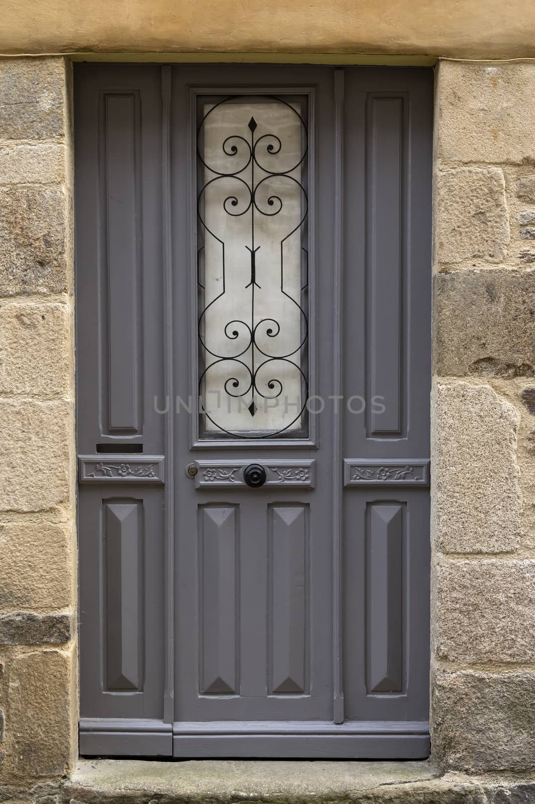 A grey door with decorations in the middle