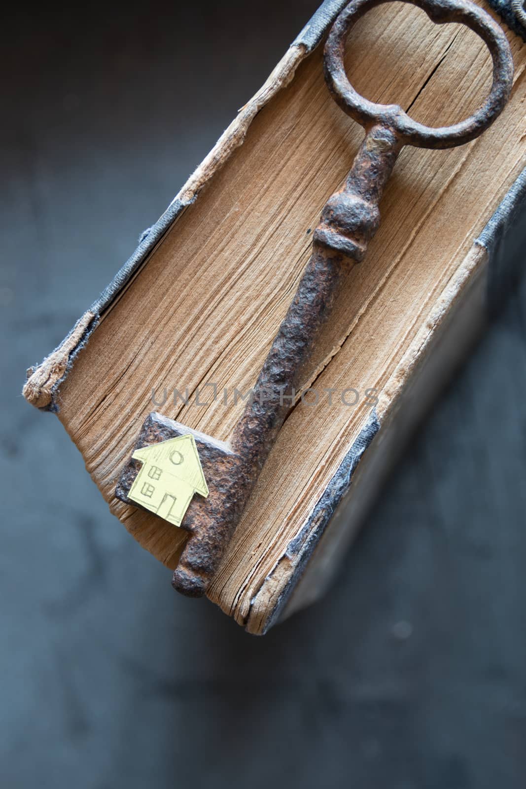 Key of house. Vintage key, old book and paper house.