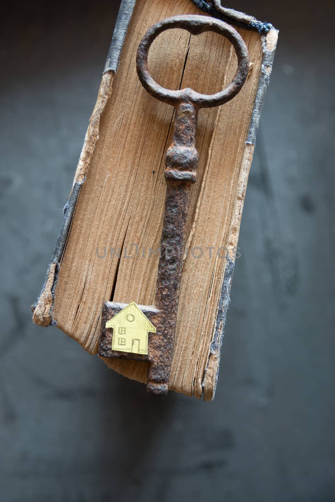 Key of house. Vintage key, old book and paper house.