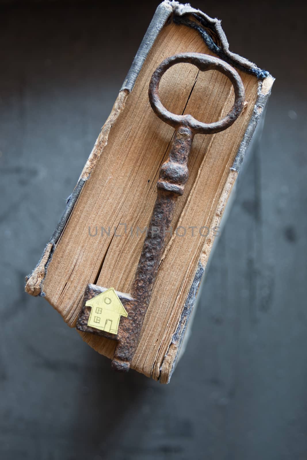 Key of house. Vintage key, old book and paper house.