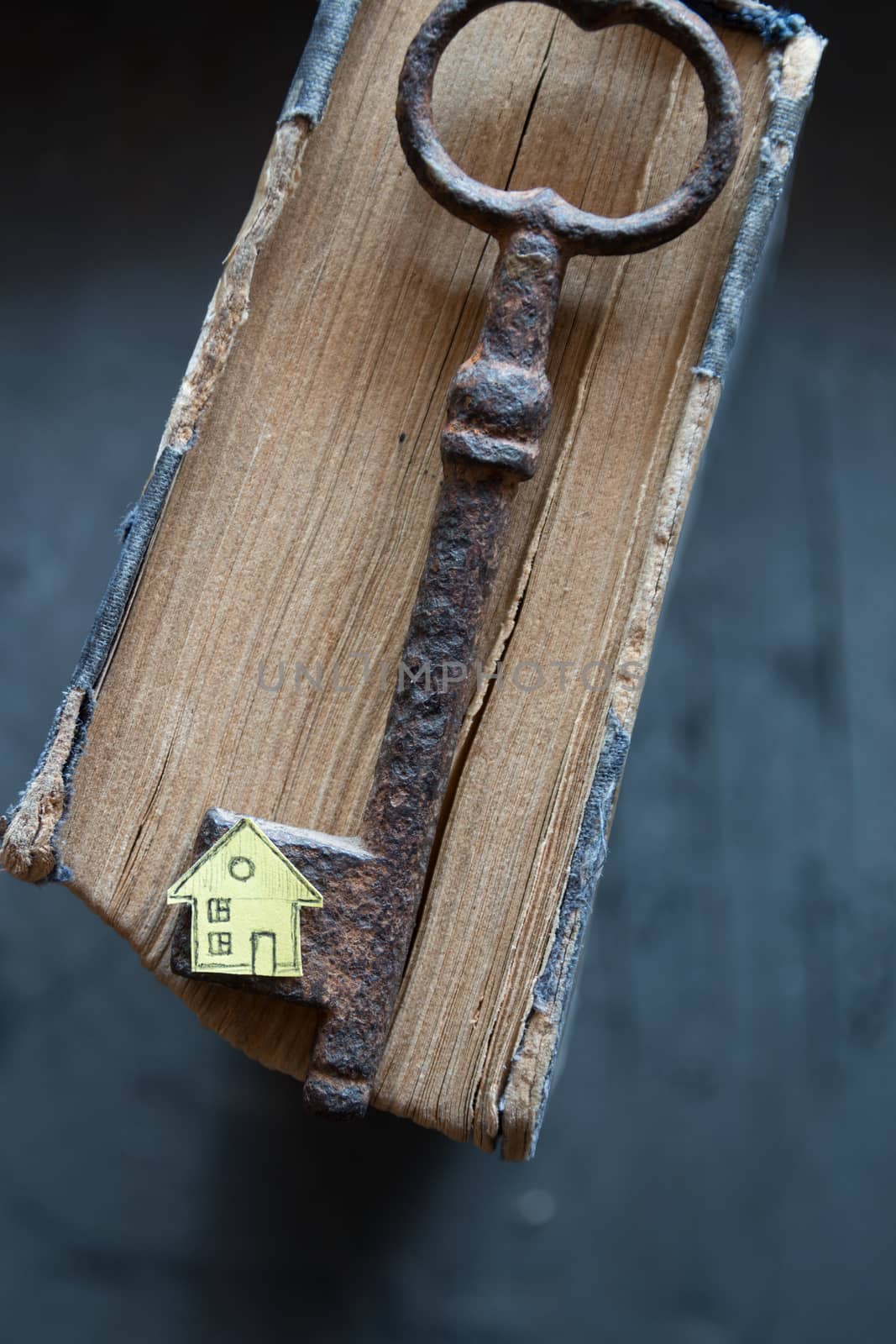 Key of house. Vintage key, old book and paper house.