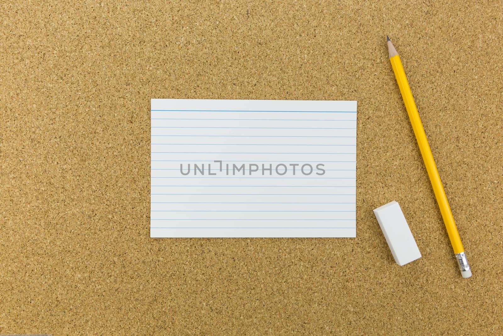 pencil and eraser with paper on cork board by urubank