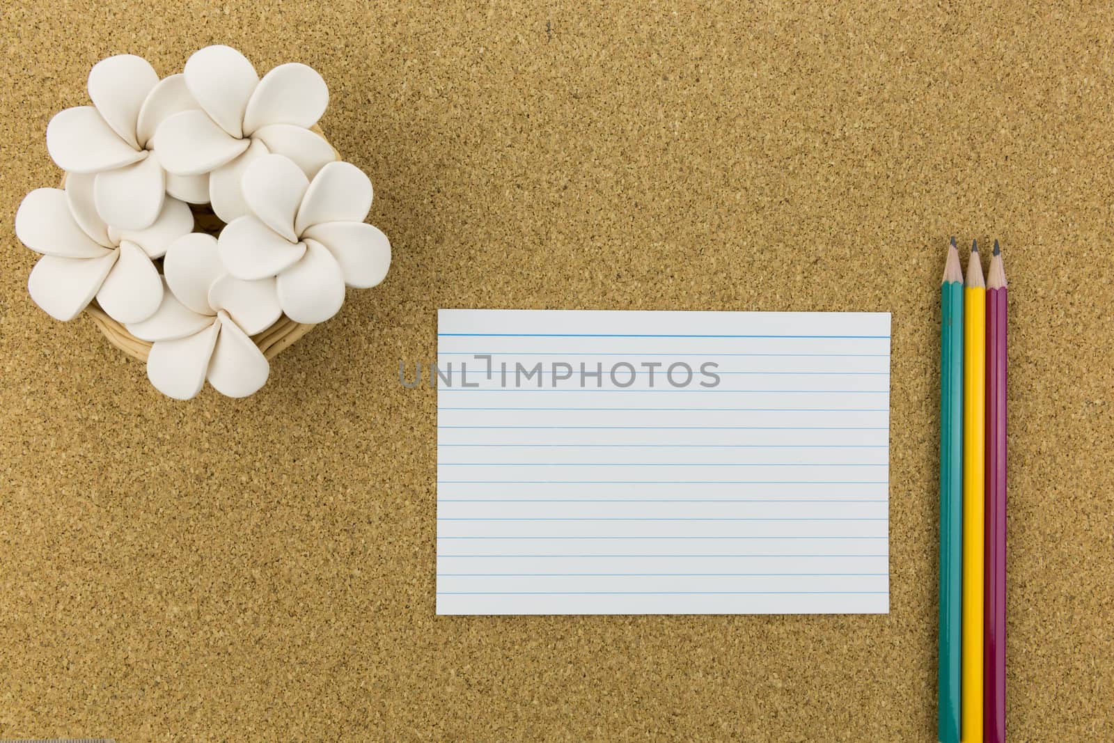 ceramic with flower and stationary on cork board by urubank