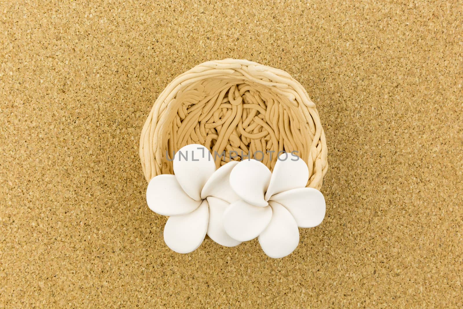 ceramic nest with flowers on cork board