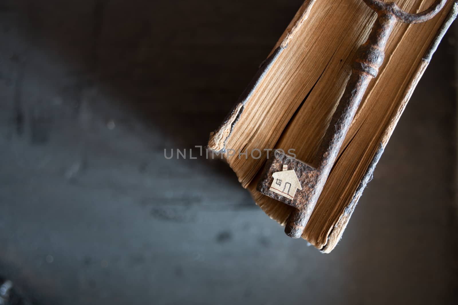 Key of house. Vintage key and old book and paper house.