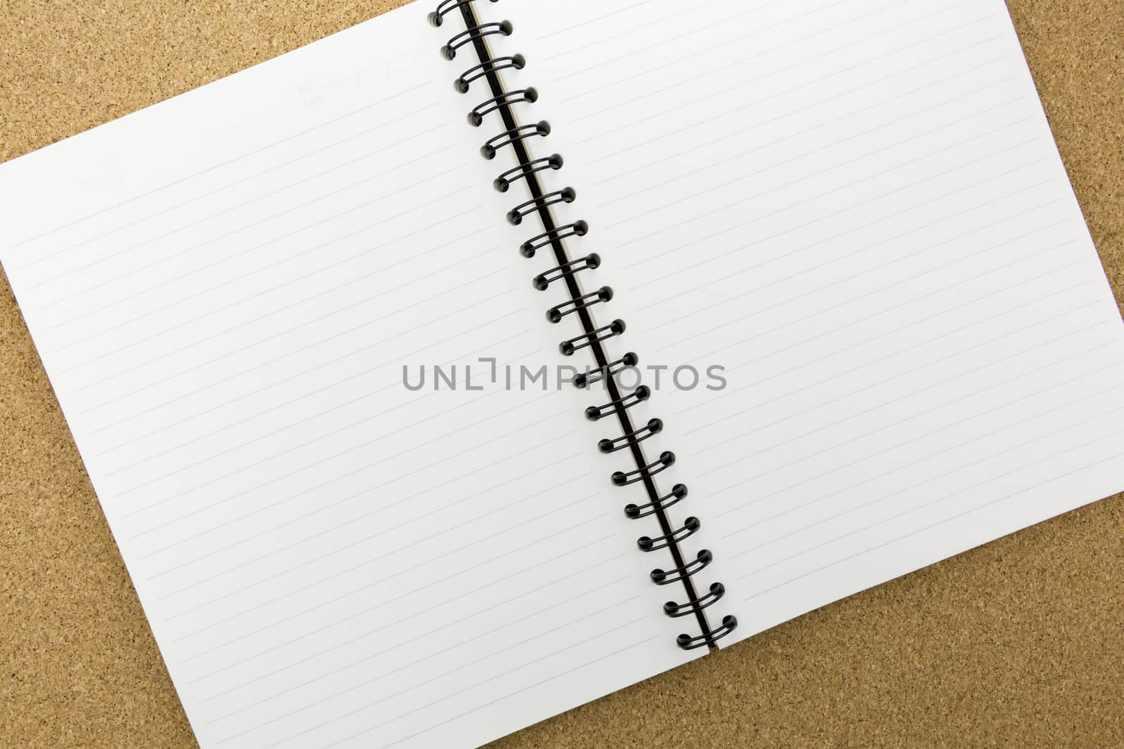 white notebook with line on cork board