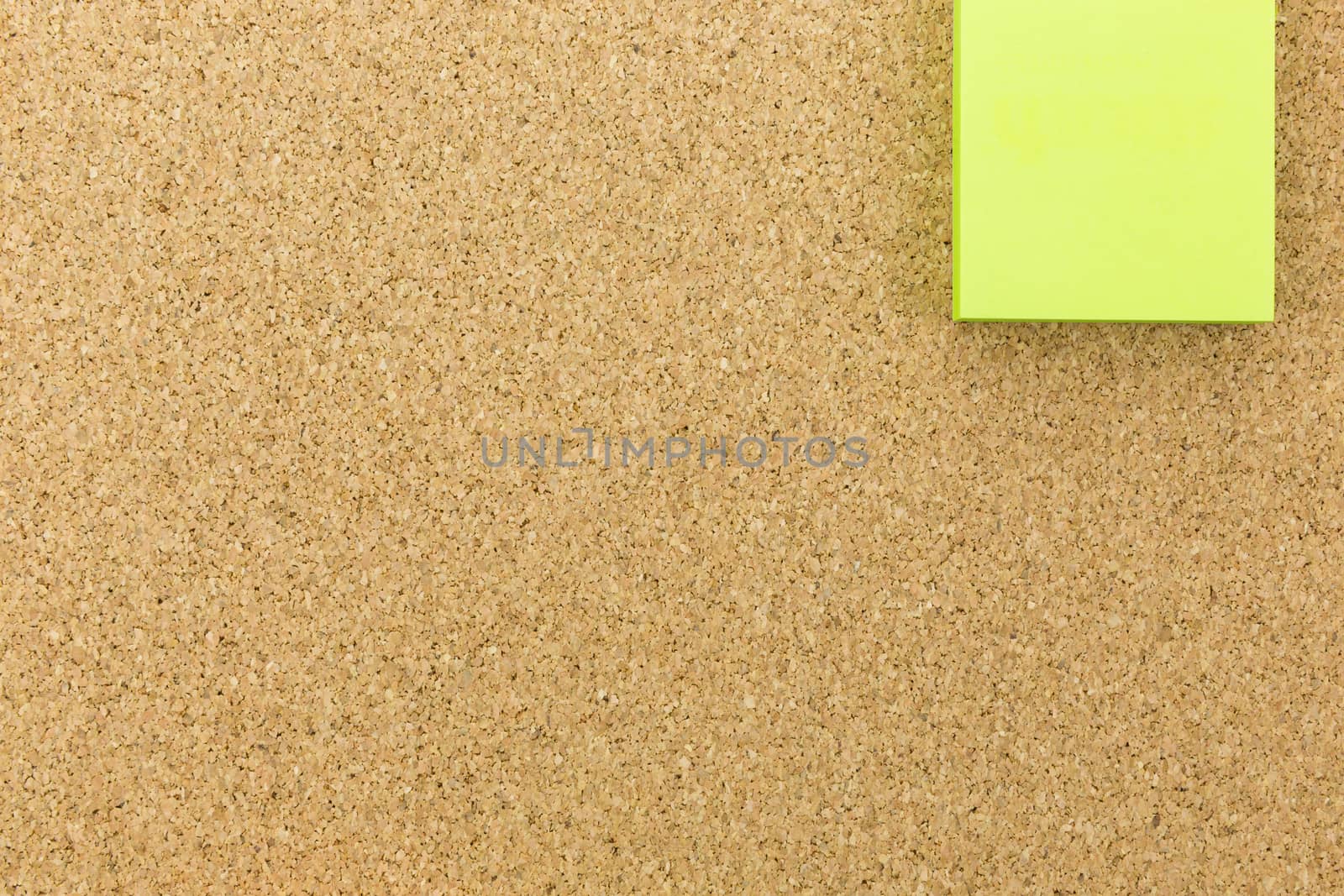 green post it on cork board by urubank