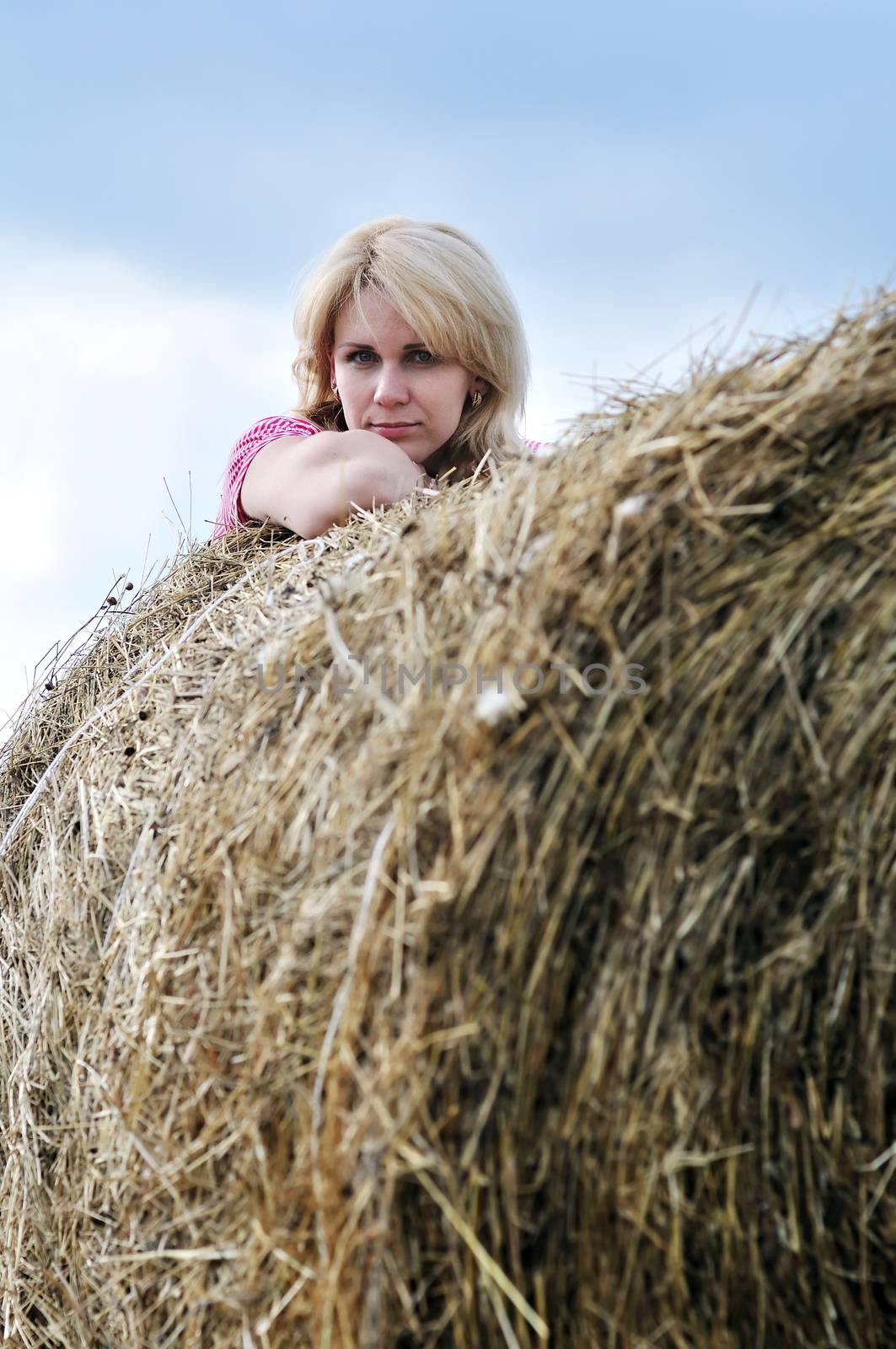 young woman and huge haystack by Reana