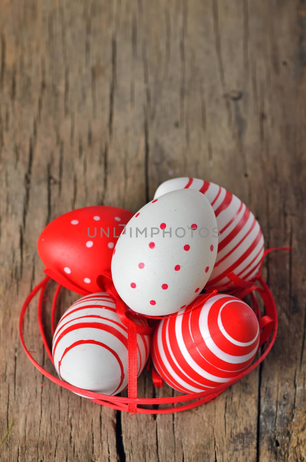 Easter eggs in nest on wooden background