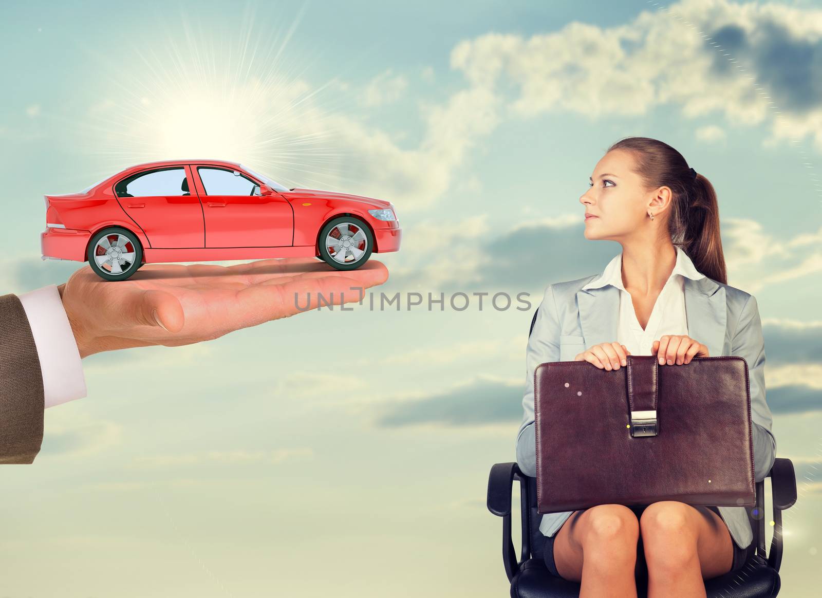 Businesswoman sitting in chair and looking at red car in mans hand