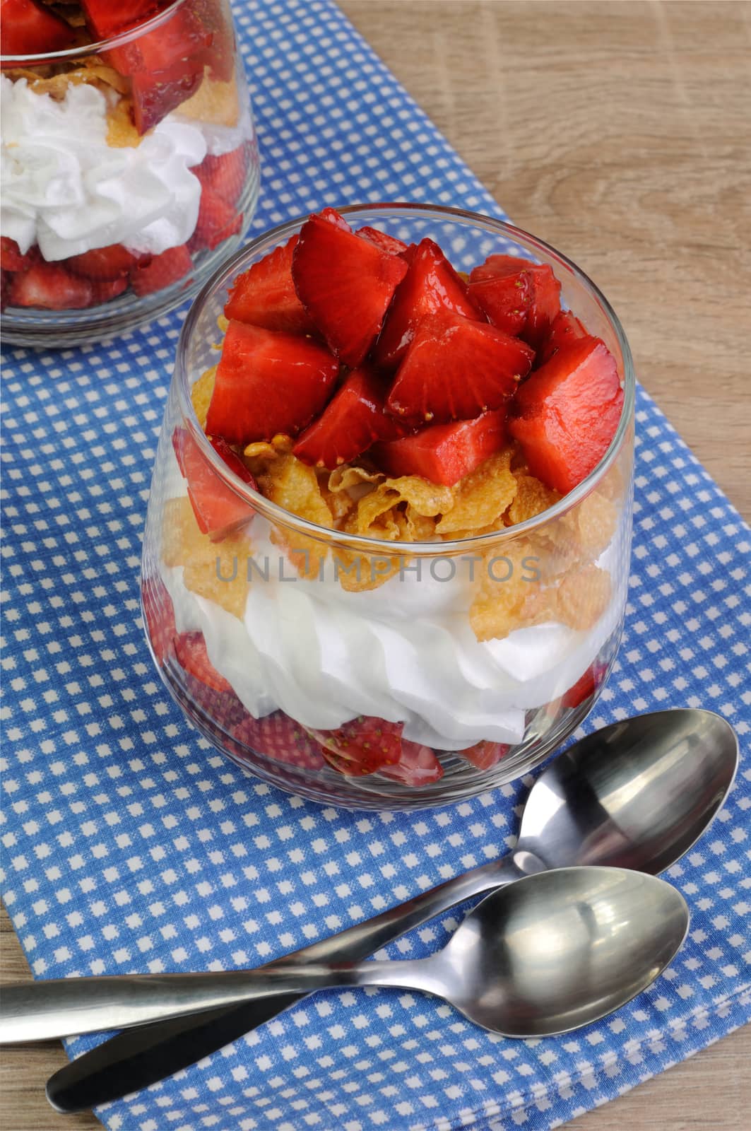 Dessert of strawberries with whipped cream and corn flakes