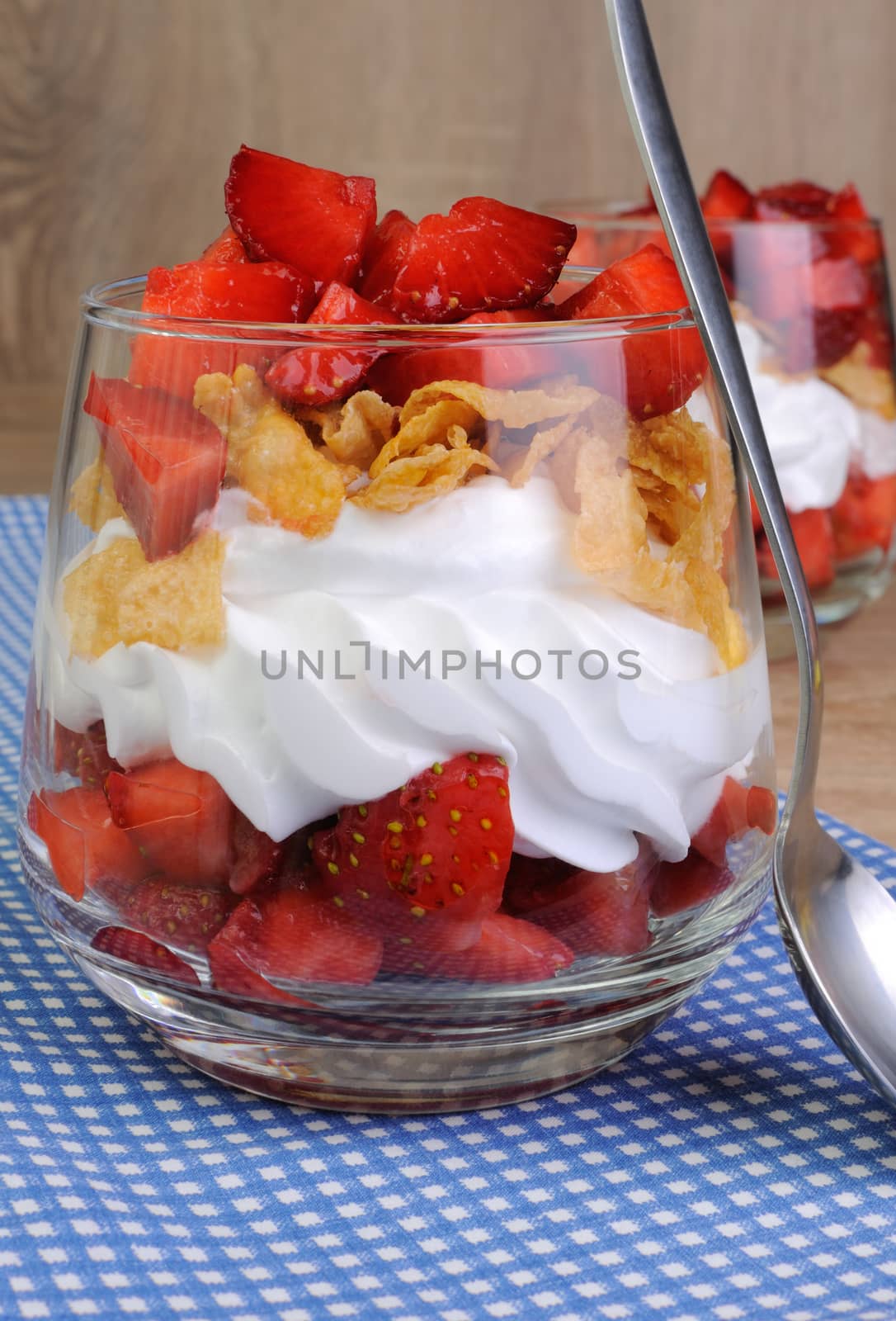 Dessert of strawberries with whipped cream and corn flakes