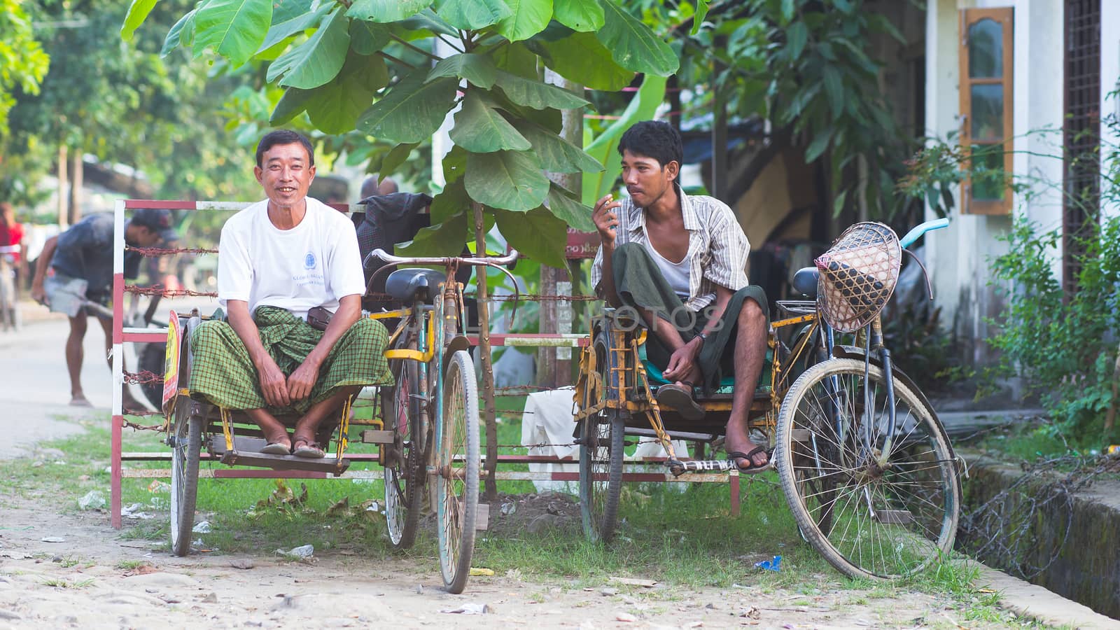 Sittwe, Rakhine State, Myanmar - October 15, 2014: Two bicycle taxis waiting for passengers in Sittwe, the capital of the Rakhine State in Myanmar.
