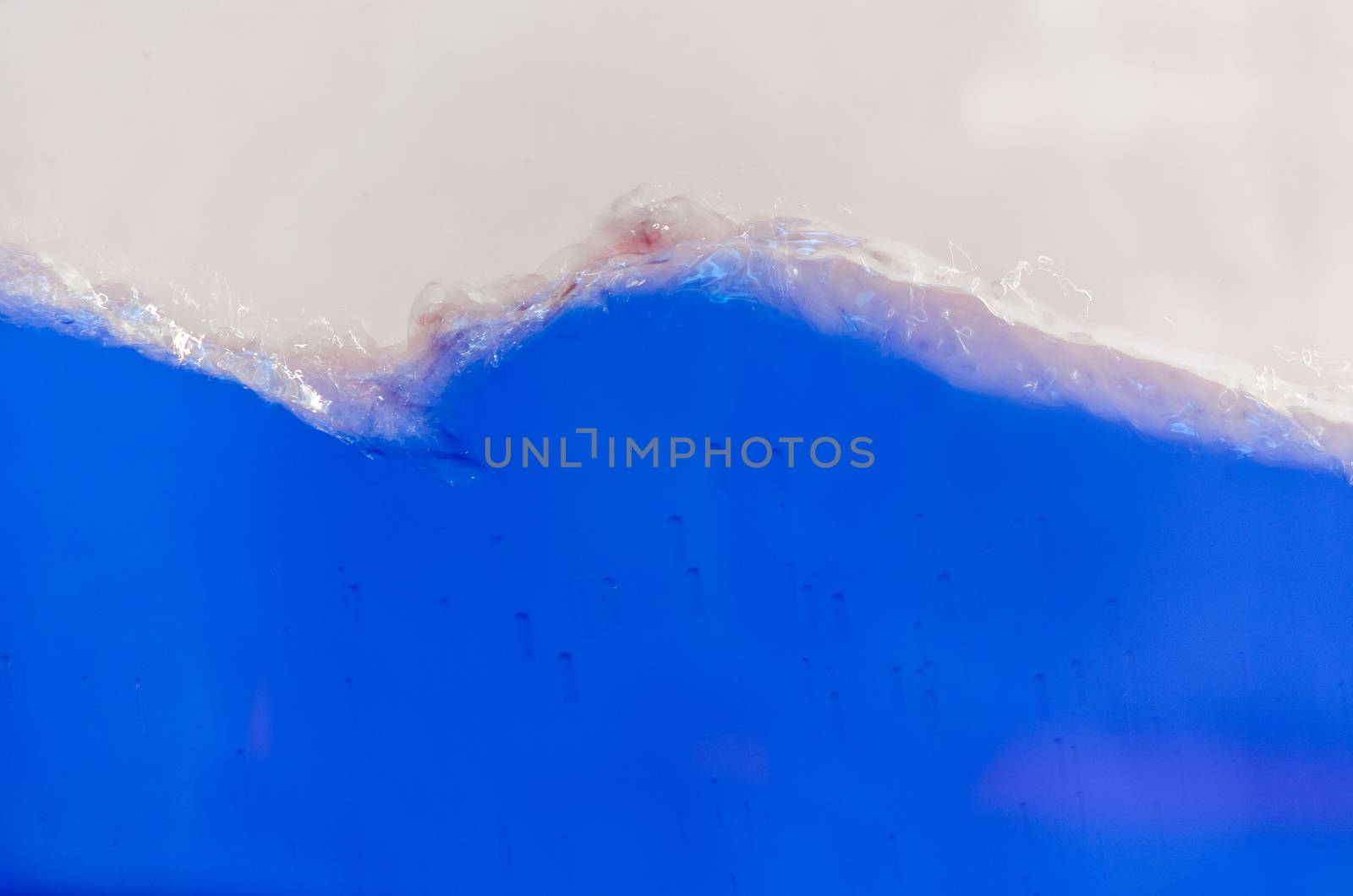 Close up of a blue liquid, water, background image. Wave Picture