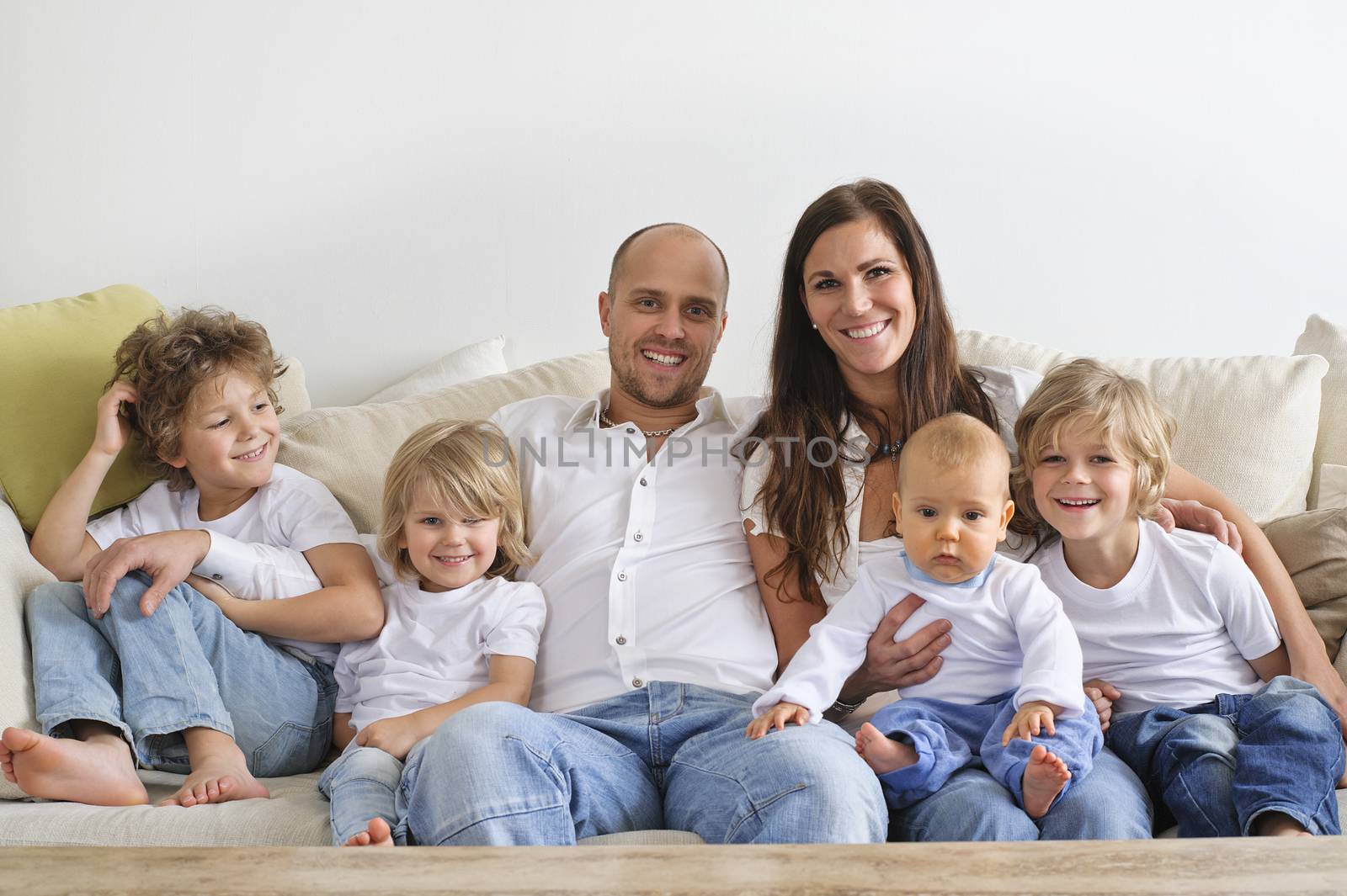 Four brothers and their parents sitting on a sofa