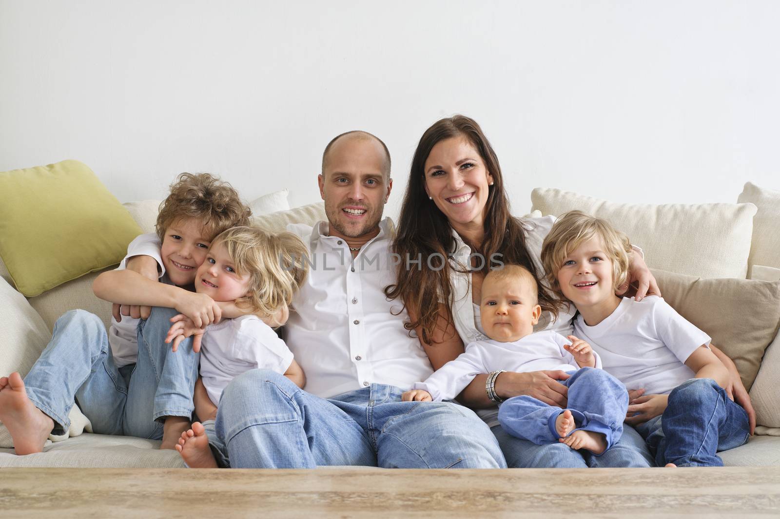 Four brothers and their parents sitting on a sofa