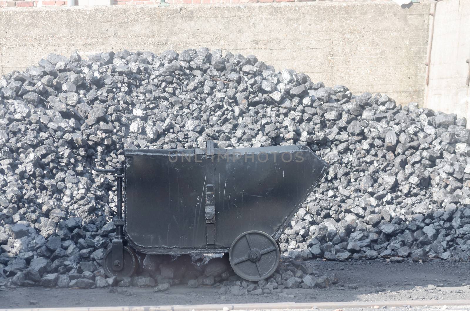 Large coal pile, storage for fuel. In the picture Trolley for coal.